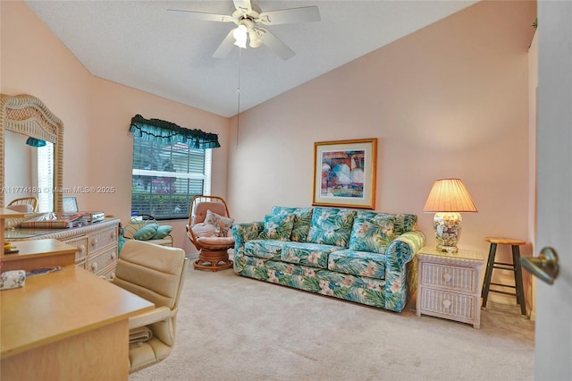 living area featuring ceiling fan, carpet, and vaulted ceiling