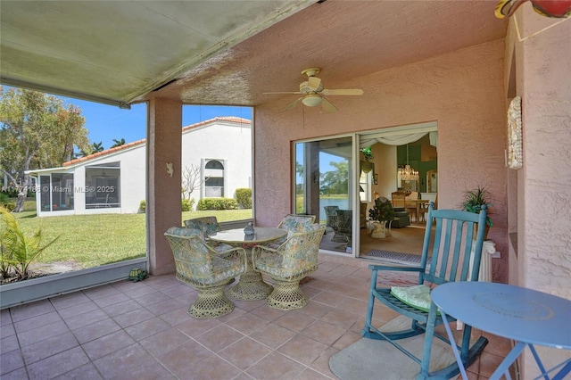 view of patio with outdoor dining space and a ceiling fan