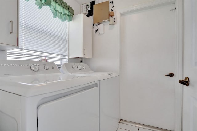 clothes washing area with cabinet space and independent washer and dryer