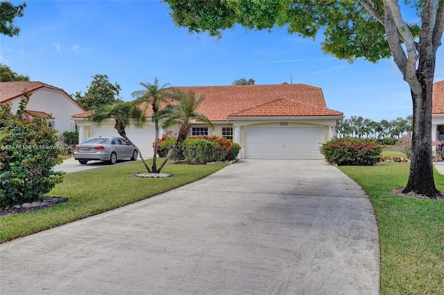 view of front of house with a front yard, a tiled roof, a garage, stucco siding, and driveway
