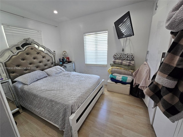 bedroom featuring light wood finished floors and recessed lighting