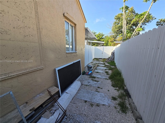view of property exterior featuring stucco siding and fence