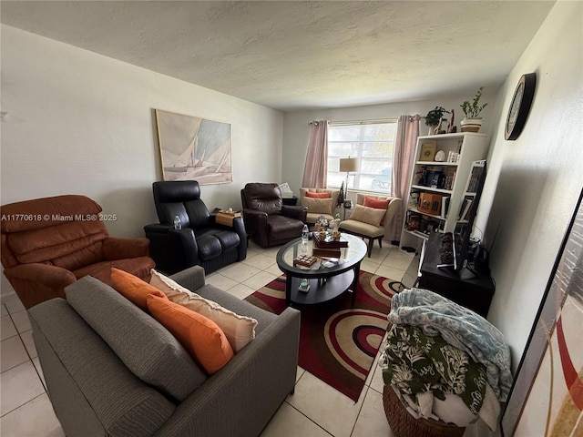 living area featuring light tile patterned flooring and a textured ceiling