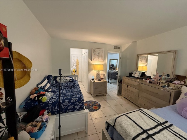 bedroom with visible vents and light tile patterned floors