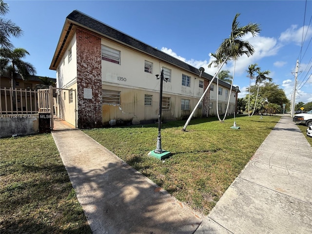 exterior space with a lawn and fence