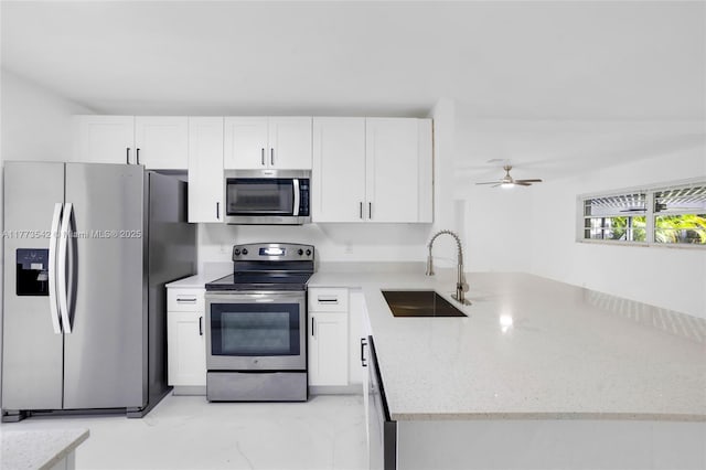 11390 NW 37th St, Coral Springs, FL 33065 - kitchen featuring light stone counters, a sink, white cabinetry, a peninsula, and stainless steel appliances