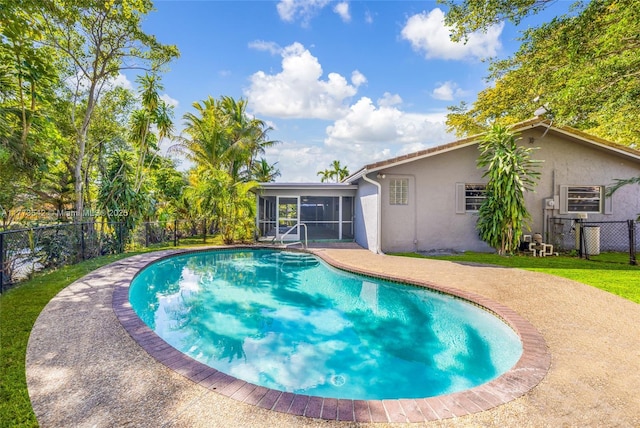 11390 NW 37th St, Coral Springs, FL 33065 - view of pool featuring a fenced backyard, a sunroom, and a yard