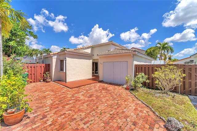 519 SW 88th Pl E, Miami, FL 33174 - view of front of house featuring stucco siding, a fenced backyard, a patio, and a tiled roof