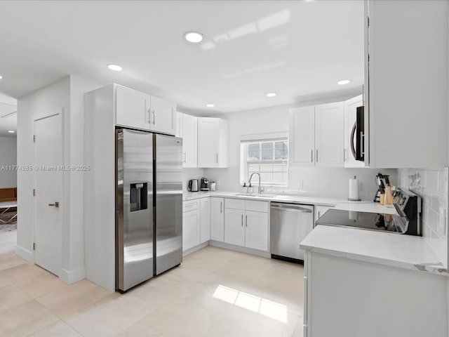 4991 SW 29th Way, Dania Beach, FL 33312 - kitchen featuring stainless steel appliances, a sink, white cabinetry, light countertops, and recessed lighting