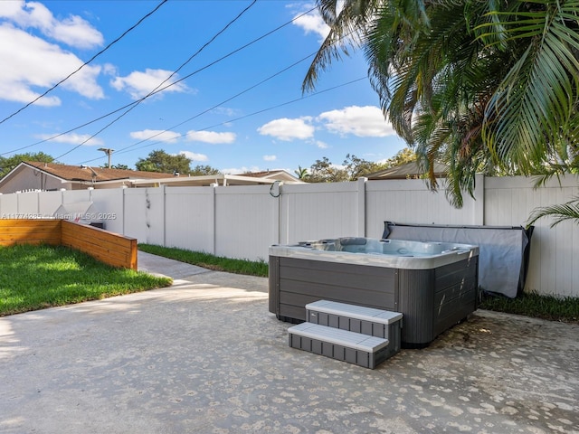 4991 SW 29th Way, Dania Beach, FL 33312 - view of patio / terrace with a hot tub and fence