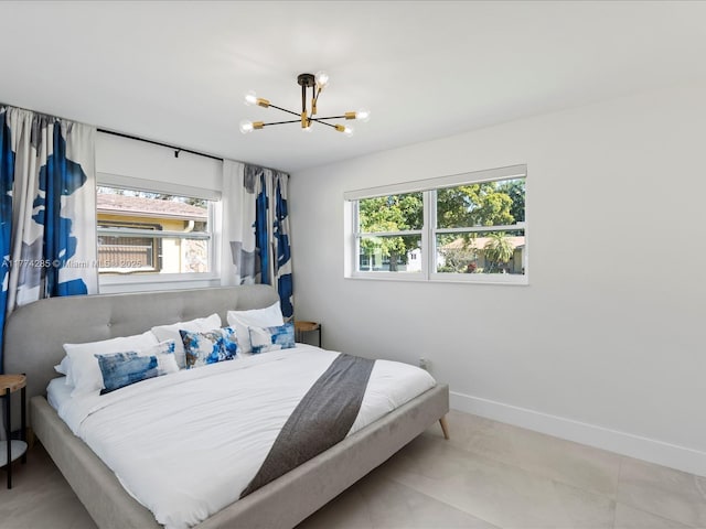 4991 SW 29th Way, Dania Beach, FL 33312 - bedroom featuring multiple windows, a chandelier, and baseboards