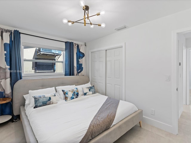 4991 SW 29th Way, Dania Beach, FL 33312 - bedroom with a closet, a chandelier, light tile patterned floors, and baseboards