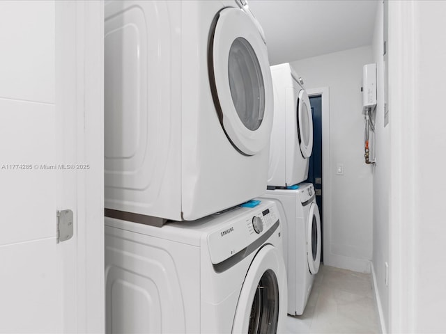 4991 SW 29th Way, Dania Beach, FL 33312 - clothes washing area with estacked washer and dryer and baseboards