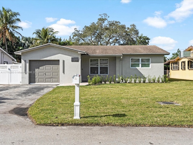 4991 SW 29th Way, Dania Beach, FL 33312 - ranch-style home featuring stucco siding, a garage, and driveway