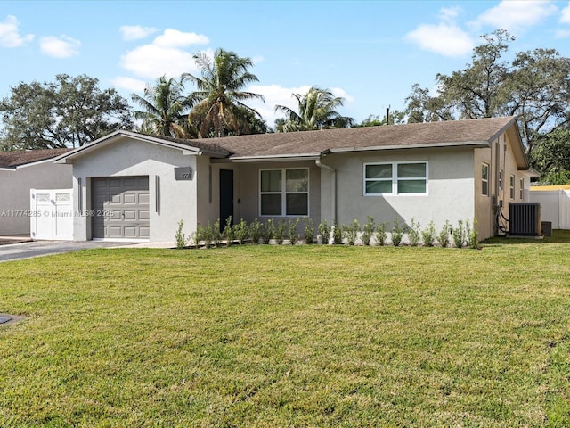 4991 SW 29th Way, Dania Beach, FL 33312 - single story home featuring stucco siding, a garage, asphalt driveway, central air condition unit, and a front lawn