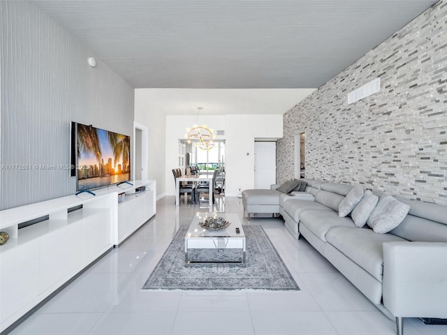 100 Bayview Dr Unit Ph01, Sunny Isles Beach, FL 33160 - living area featuring light tile patterned flooring, an accent wall, and an inviting chandelier