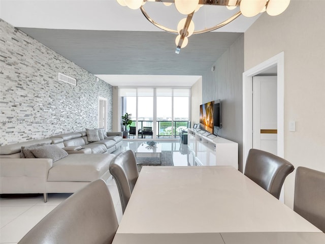 100 Bayview Dr Unit Ph01, Sunny Isles Beach, FL 33160 - dining room featuring light tile patterned flooring, an accent wall, a chandelier, a wall of windows, and visible vents