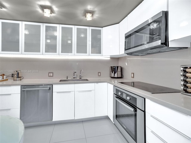 100 Bayview Dr Unit Ph01, Sunny Isles Beach, FL 33160 - kitchen featuring white cabinetry, light countertops, a sink, and appliances with stainless steel finishes