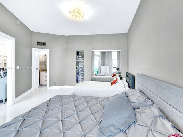 100 Bayview Dr Unit Ph01, Sunny Isles Beach, FL 33160 - bedroom featuring baseboards, visible vents, tile patterned flooring, and ensuite bath