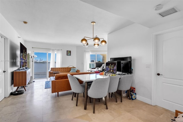 dining space with a chandelier and baseboards