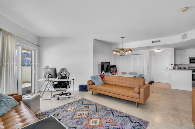 living area with a chandelier, light tile patterned flooring, and an office area
