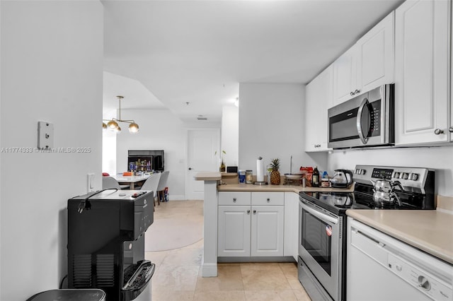 kitchen with stainless steel appliances, white cabinets, a peninsula, light countertops, and a chandelier