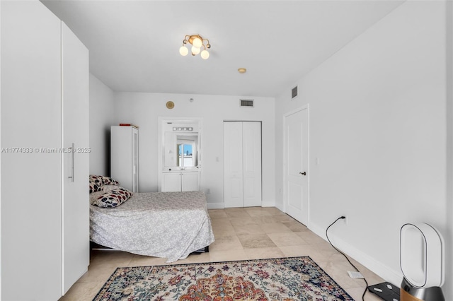 bedroom featuring a closet and light tile patterned floors