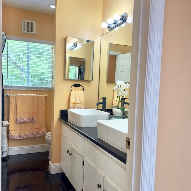 1950 S Tanner Rd, Orlando, FL 32820 - bathroom with tile patterned flooring, a textured wall, vanity, and toilet