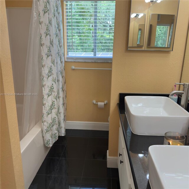 1950 S Tanner Rd, Orlando, FL 32820 - full bathroom with tile patterned floors, baseboards, shower / bath combination with curtain, and double vanity