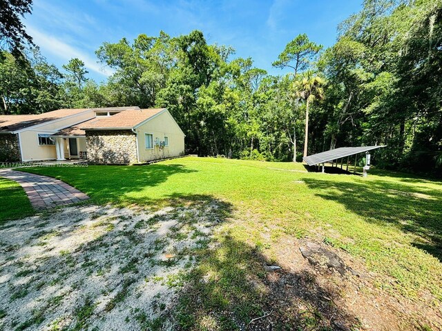 1950 S Tanner Rd, Orlando, FL 32820 - view of green lawn with a carport