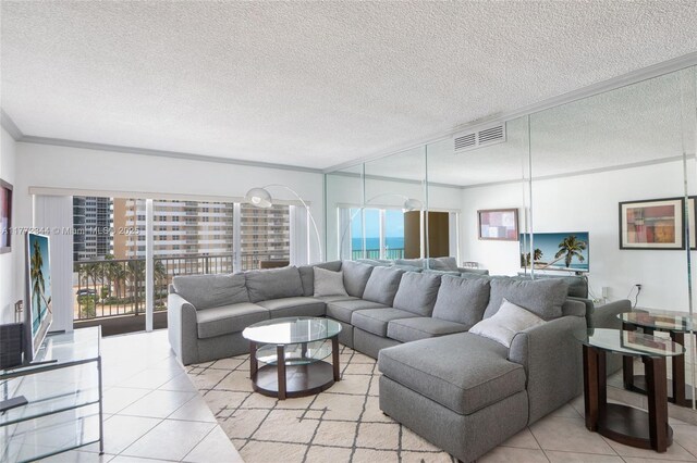 1950 S Ocean Dr Unit 6G, Hallandale Beach, FL 33009 - living area with plenty of natural light, tile patterned floors, crown molding, and a textured ceiling
