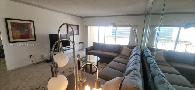 1950 S Ocean Dr Unit 6G, Hallandale Beach, FL 33009 - tiled living area featuring plenty of natural light, crown molding, and a textured ceiling
