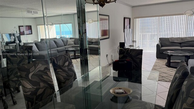 1950 S Ocean Dr Unit 6G, Hallandale Beach, FL 33009 - living area featuring a textured ceiling, crown molding, and light tile patterned floors