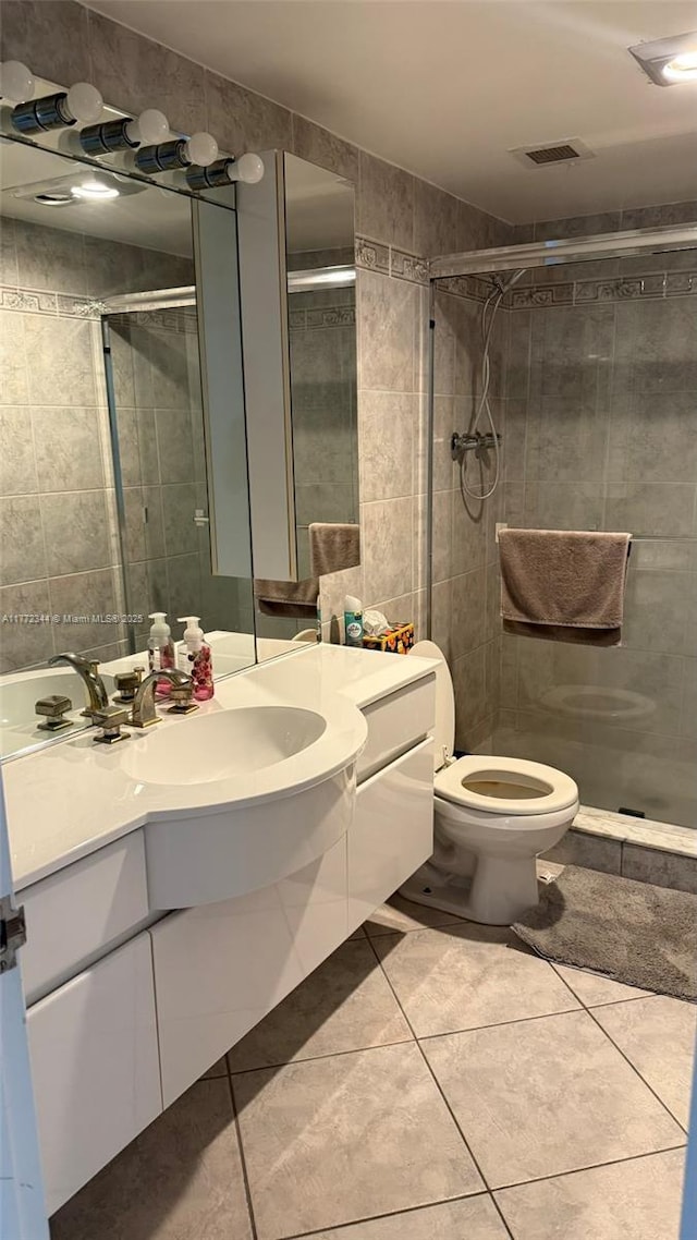 1950 S Ocean Dr Unit 6G, Hallandale Beach, FL 33009 - bathroom with a stall shower, vanity, tile patterned flooring, toilet, and tile walls