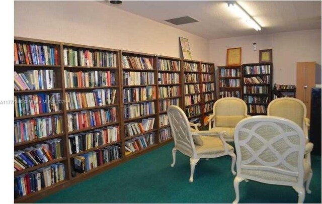 1950 S Ocean Dr Unit 6G, Hallandale Beach, FL 33009 - living area featuring wall of books and carpet floors