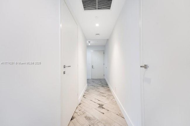 1300 Brickell Bay Dr Unit 601, Miami, FL 33131 - hallway with visible vents, recessed lighting, baseboards, and light wood-type flooring