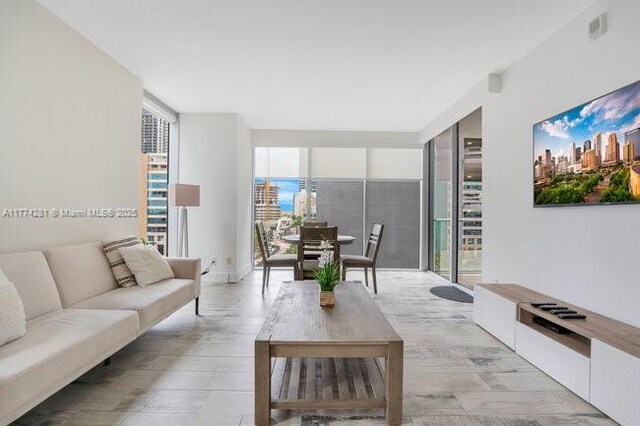 1300 Brickell Bay Dr Unit 601, Miami, FL 33131 - living room featuring visible vents, light wood finished floors, and floor to ceiling windows