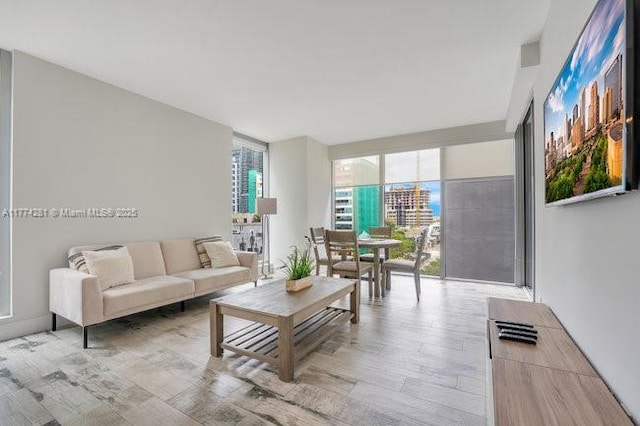 1300 Brickell Bay Dr Unit 601, Miami, FL 33131 - living room with light wood-type flooring and expansive windows