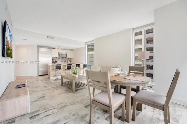 1300 Brickell Bay Dr Unit 601, Miami, FL 33131 - dining area with light wood-type flooring and visible vents