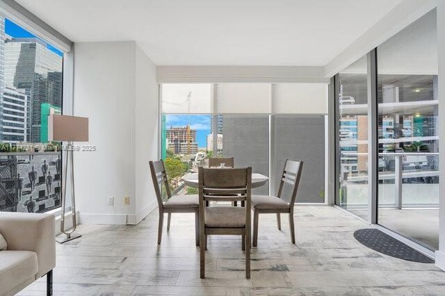 1300 Brickell Bay Dr Unit 601, Miami, FL 33131 - dining area featuring a healthy amount of sunlight, floor to ceiling windows, and a city view