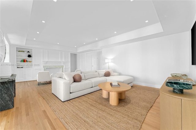 6675 Roxbury Ln, Miami Beach, FL 33141 - living area featuring light wood-style floors, built in features, a tray ceiling, recessed lighting, and baseboards