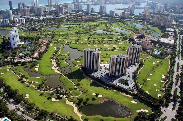 aerial view featuring golf course view, a water view, and a city view