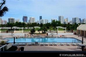 view of swimming pool with a view of city and a patio