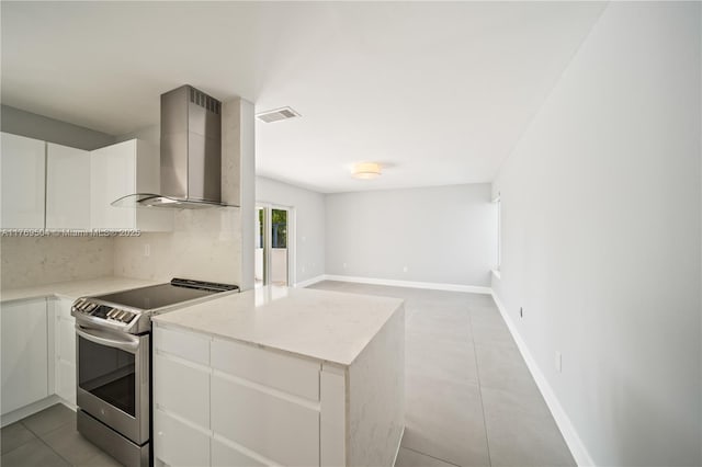 6881 SW 94th Ave, Miami, FL 33173 - kitchen with stainless steel range with electric cooktop, wall chimney range hood, light tile patterned floors, decorative backsplash, and white cabinetry