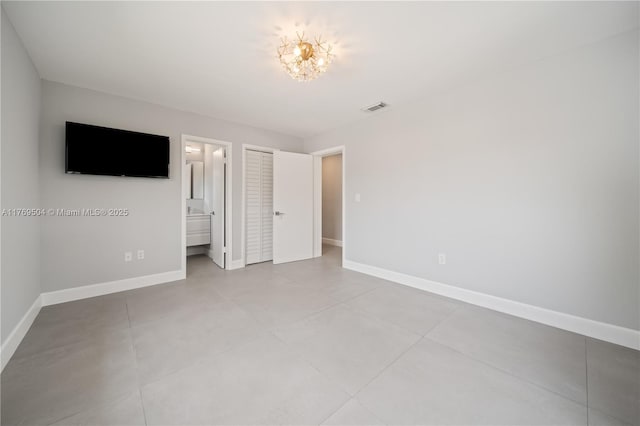 6881 SW 94th Ave, Miami, FL 33173 - unfurnished bedroom with baseboards, ensuite bathroom, and tile patterned flooring