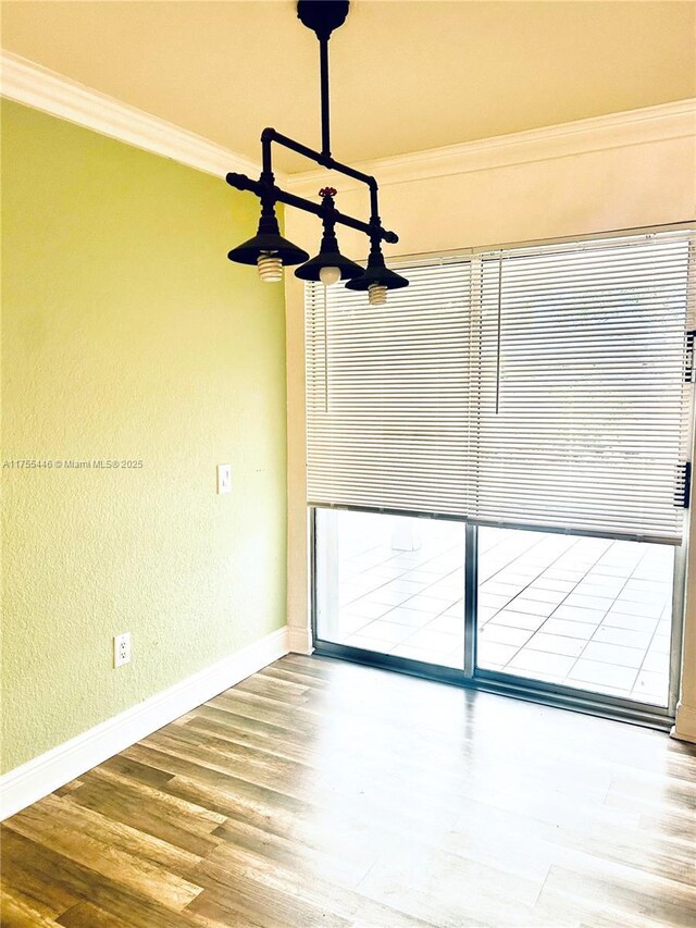 15016 SW 139th Pl, Miami, FL 33186 - spare room with crown molding, baseboards, wood finished floors, and a textured wall