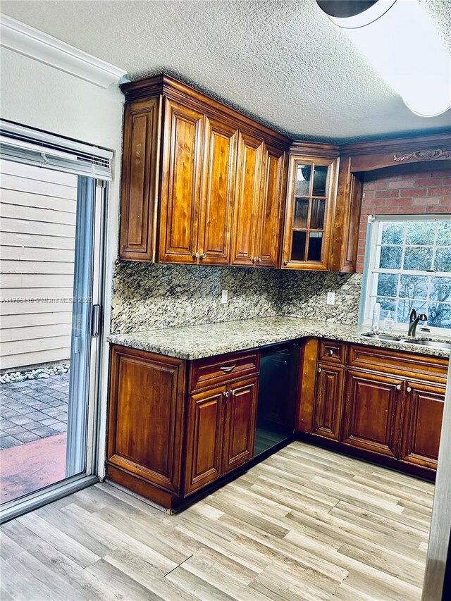 15016 SW 139th Pl, Miami, FL 33186 - kitchen with a textured ceiling, a sink, light wood-type flooring, light stone counters, and glass insert cabinets