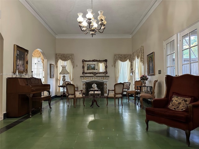 sitting room with tile patterned floors, a fireplace, an inviting chandelier, and crown molding