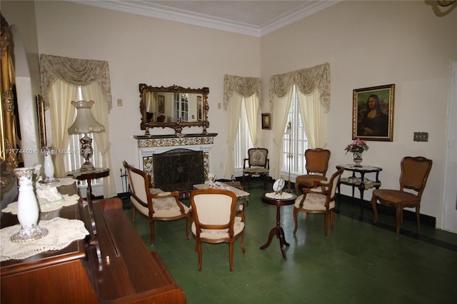 sitting room with tile patterned floors, a fireplace, and ornamental molding