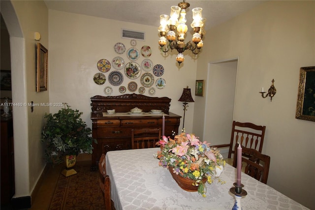 dining room with an inviting chandelier, baseboards, and visible vents